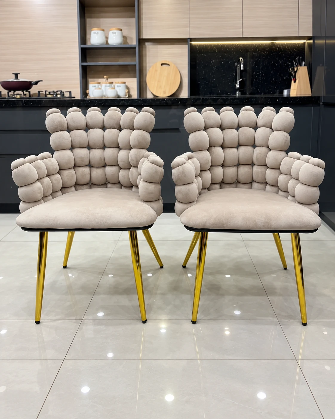 Pair of cream upholstered accent chairs with gold-coloured legs