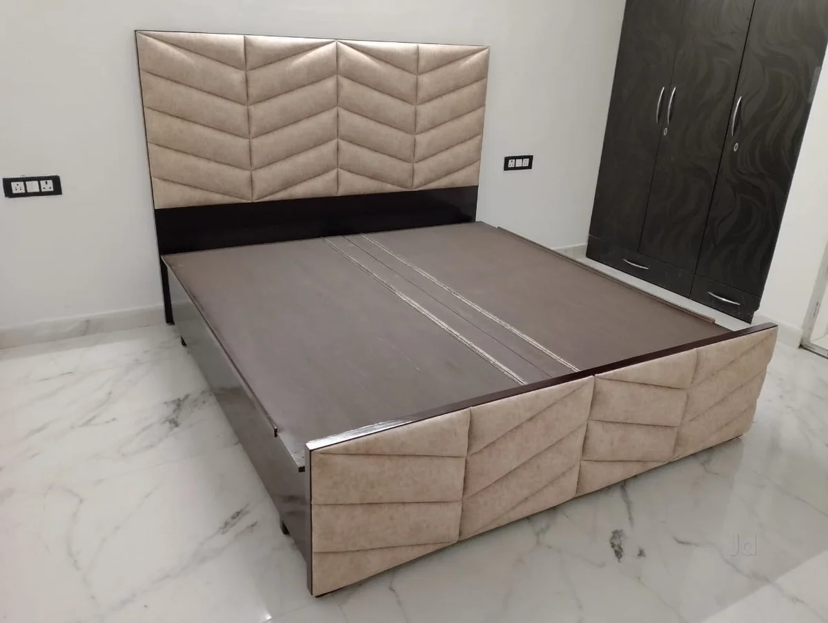 Upholstered bed with a geometric padded headboard