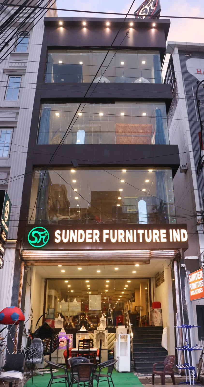 Front elevation of Sunder Furniture Industries on Bamba Road, Kanpur, with its illuminated SFi logo and entrance